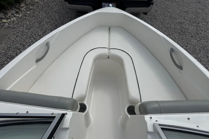 Slide: The Image of 2012 Bayliner 175 boat interior with white seating and gray accents. - 17