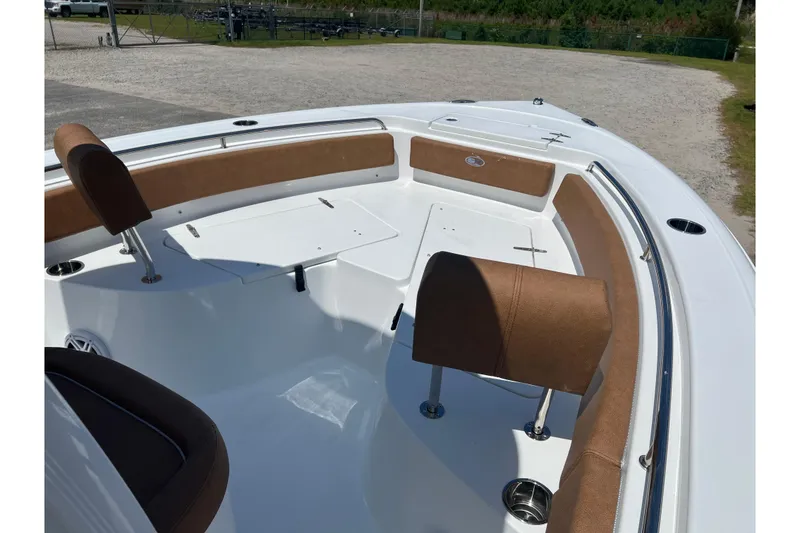 Slide: The Image of 2026 Sea Hunt Ultra 229 boat interior with brown seating and white deck. - 12