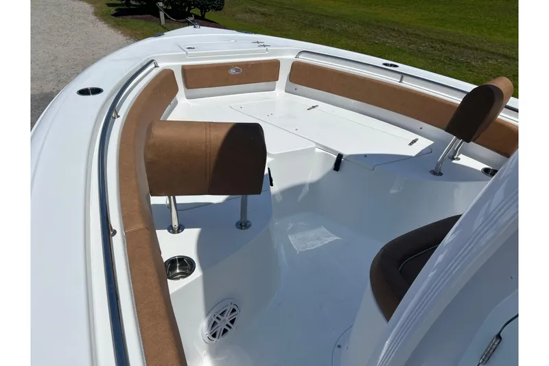 Slide: The Image of 2026 Sea Hunt Ultra 229 boat interior with brown seating and white deck. - 13
