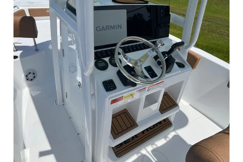 Slide: The Image of 2026 Sea Hunt Ultra 229 boat console with Garmin navigation and steering wheel. - 14