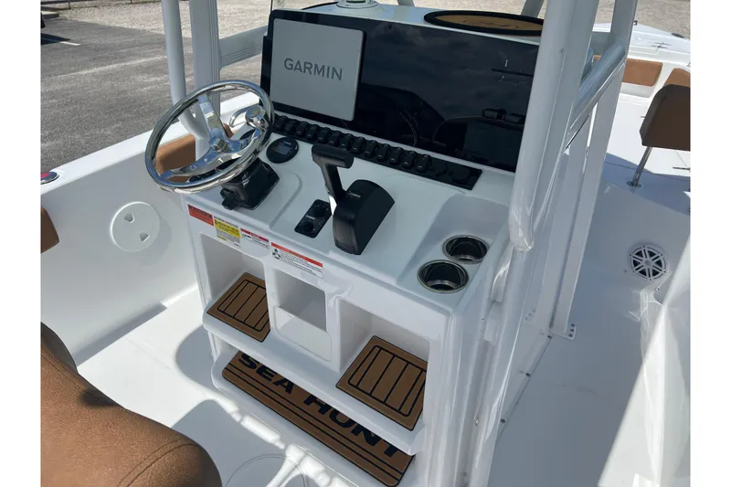 Slide: The Image of 2026 Sea Hunt Ultra 229 boat console with Garmin navigation and steering wheel. - 15