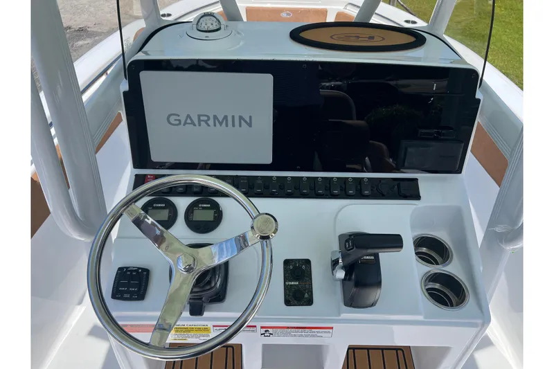 Slide: The Image of 2026 Sea Hunt Ultra 229 boat dashboard with Garmin display and Yamaha controls. - 16