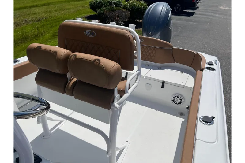 Slide: The Image of 2026 Sea Hunt Ultra 229 boat interior with tan seating and white deck. - 17