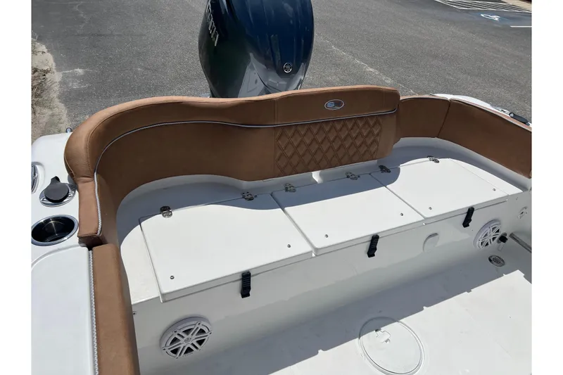 Slide: The Image of 2026 Sea Hunt Ultra 229 boat interior with cushioned seating and storage compartments. - 19