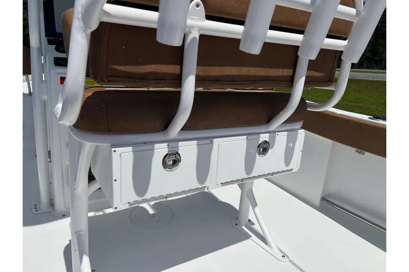Slide: The Image of 2026 Sea Hunt Ultra 229 boat seat with storage compartment and white frame. - 24
