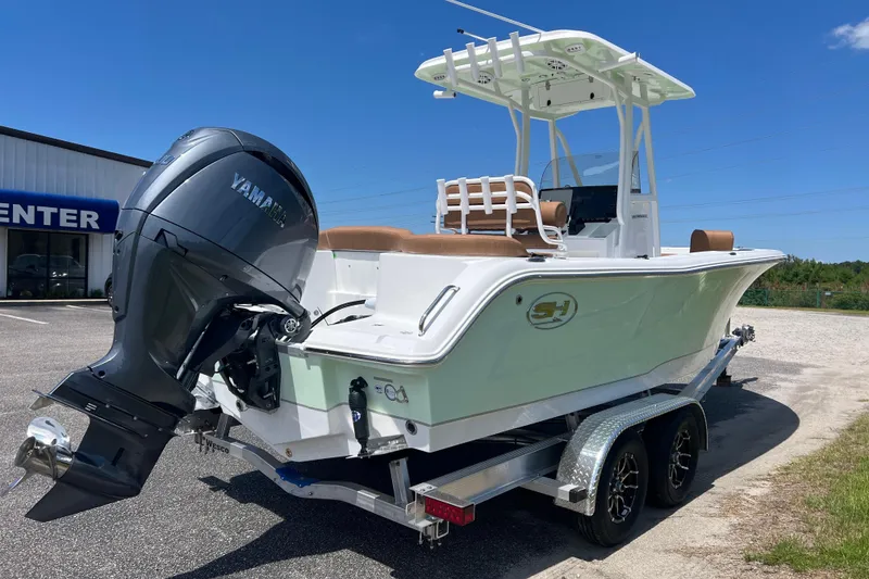 Slide: The Image of 2026 Sea Hunt Ultra 229 boat with Yamaha engine on trailer, parked outdoors. - 6