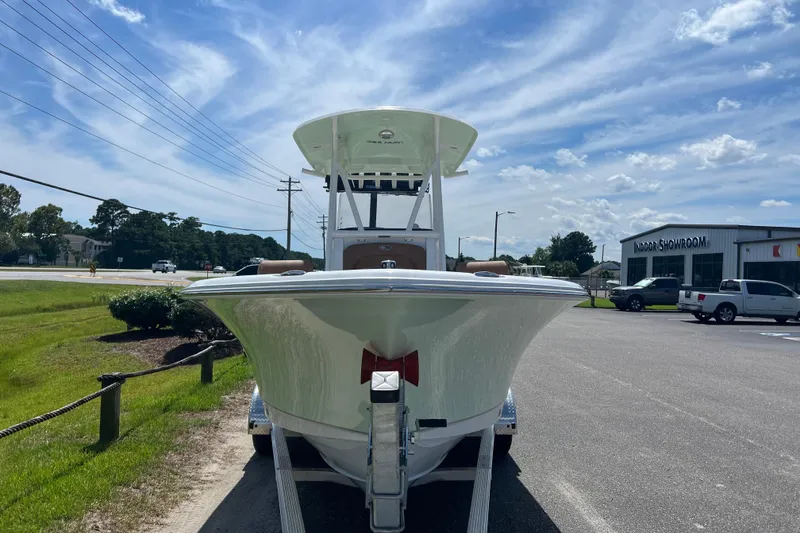 Slide: The Image of 2026 Sea Hunt Ultra 229 boat on trailer, outdoor showroom, sunny day. - 7