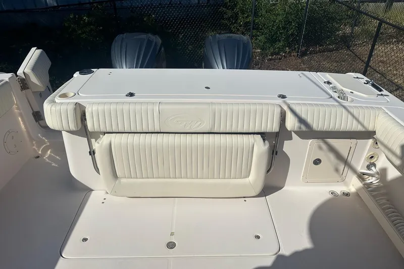 Slide: The Image of 2008 Grady-White Canyon 336 boat interior with white seating and storage compartments. - 11