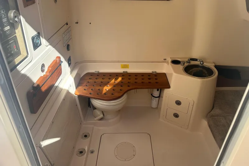 Slide: The Image of 2008 Grady-White Canyon 336 boat interior with toilet and sink area. - 14