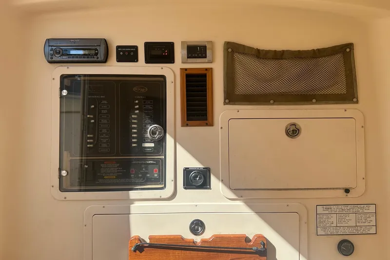 Slide: The Image of Control panel of a 2008 Grady-White Canyon 336 boat with various switches and compartments. - 15