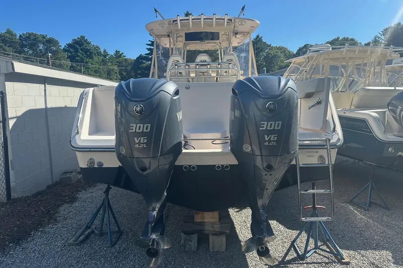 Slide: The Image of 2008 Grady-White Canyon 336 boat with dual Yamaha 300 V6 engines, docked outdoors. - 2