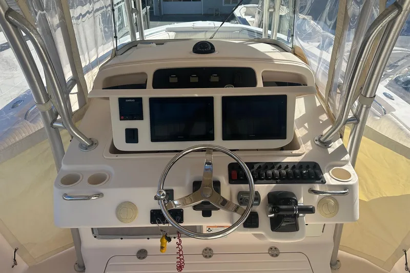 Slide: The Image of Helm of 2008 Grady-White Canyon 336 boat with dual screens and steering wheel. - 7