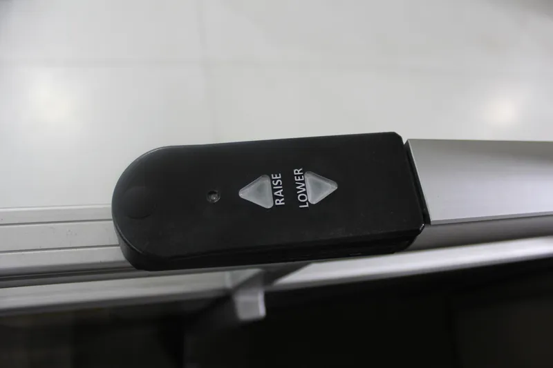 Slide: The Image of Control panel on 2023 Sun Tracker Party Barge 22 RF DLX with raise and lower buttons. - 10