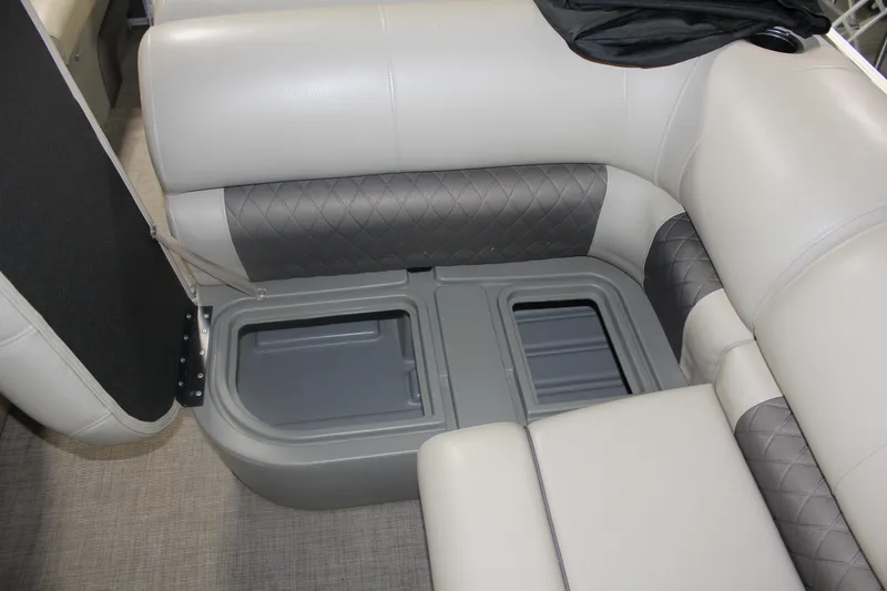 Slide: The Image of 2023 Sun Tracker Party Barge 22 RF DLX interior storage compartment with cushioned seating. - 13