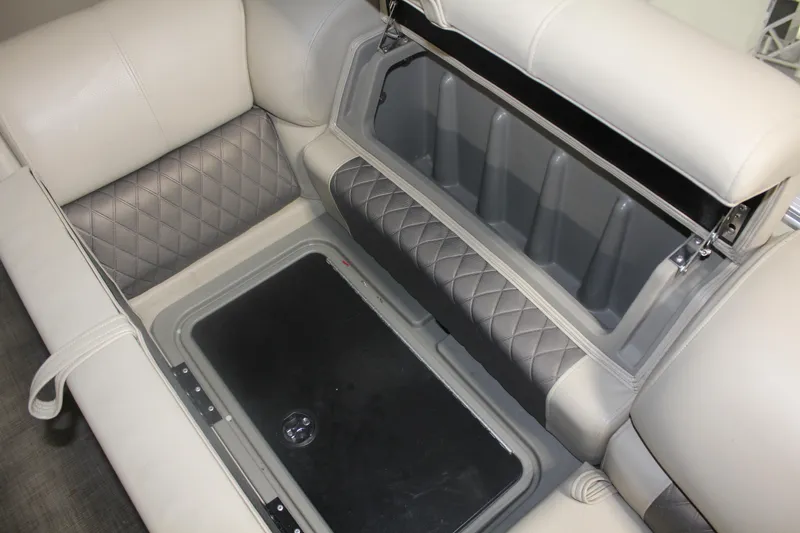 Slide: The Image of 2023 Sun Tracker Party Barge 22 RF DLX storage compartment with cushioned seating. - 14