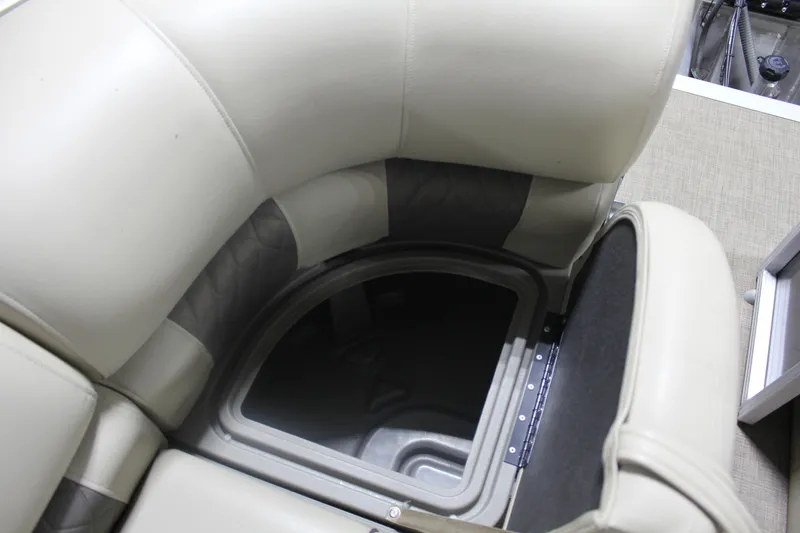 Slide: The Image of 2023 Sun Tracker Party Barge 22 RF DLX storage compartment with cushioned seating. - 16