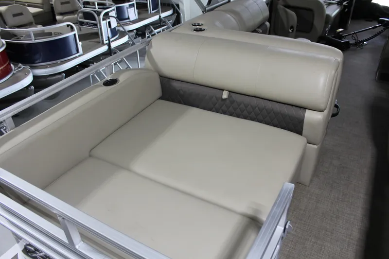 Slide: The Image of 2023 Sun Tracker Party Barge 22 RF DLX interior seating, beige upholstery, spacious layout. - 17