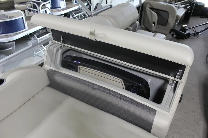 Slide: The Image of 2023 Sun Tracker Party Barge 22 RF DLX interior storage compartment with cushioned seating. - 18