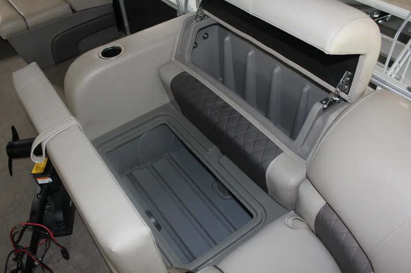 Slide: The Image of 2023 Sun Tracker Party Barge 22 RF DLX storage compartment with cushioned seating and cup holder. - 21