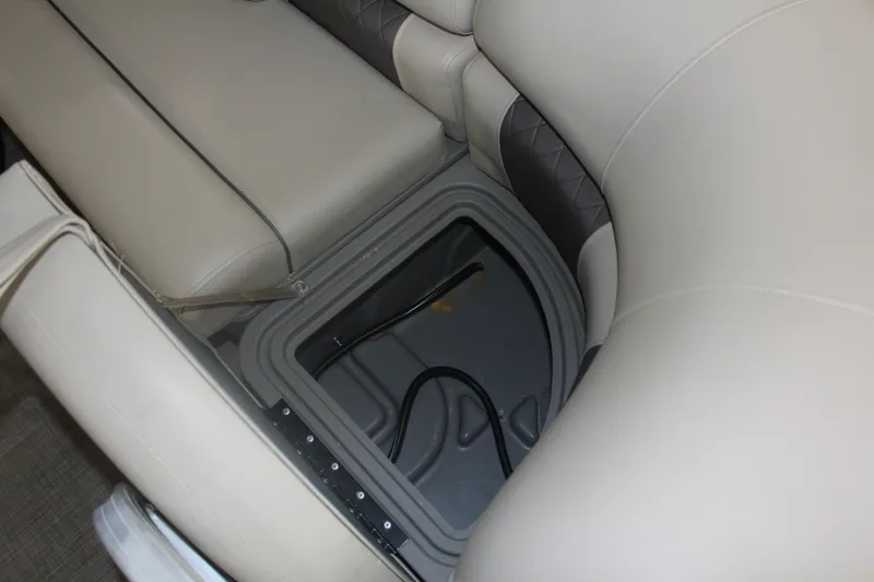 Slide: The Image of 2023 Sun Tracker Party Barge 22 RF DLX storage compartment with cushioned seating. - 22