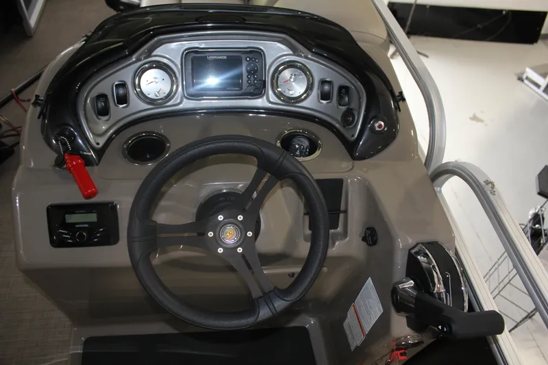 Slide: The Image of 2023 Sun Tracker Party Barge 22 RF DLX dashboard with steering wheel and controls. - 4