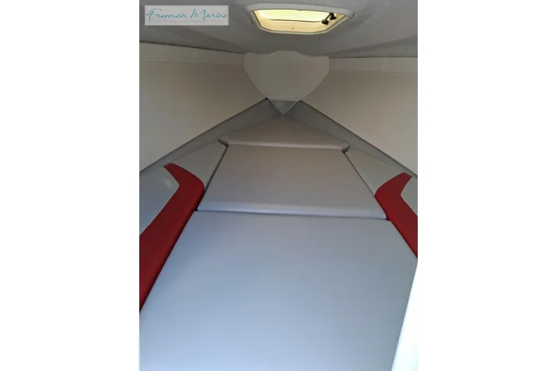 Slide: The Image of Interior cabin of a 2007 Baja 245 boat with red and white upholstery. - 12