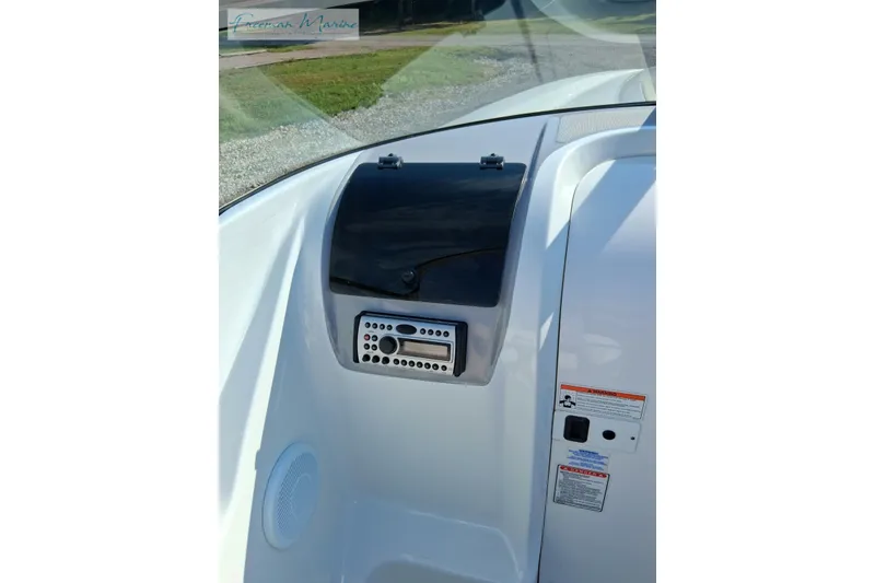 Slide: The Image of 2007 Baja 245 boat dashboard with stereo system and storage compartment. - 13