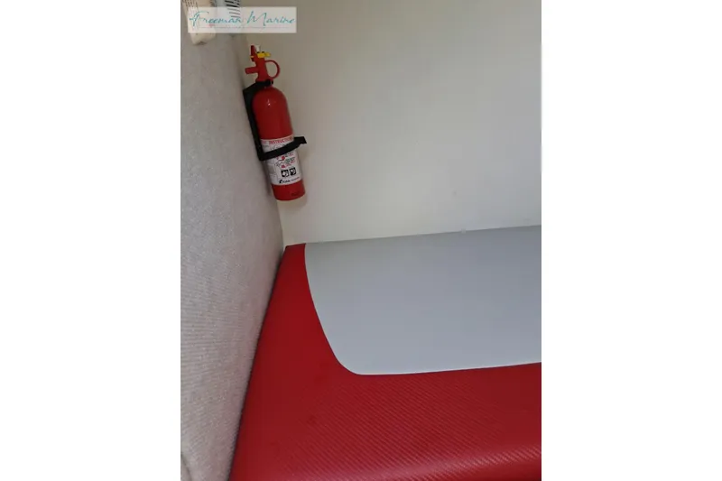 Slide: The Image of Interior of 2007 Baja 245 boat with red fire extinguisher and red seating. - 14