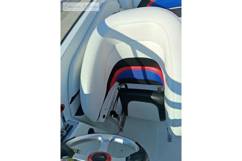 Slide: The Image of 2007 Baja 245 boat interior with white, red, and blue seating and steering wheel. - 17