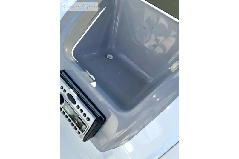 Slide: The Image of 2007 Baja 245 boat interior with control panel and storage compartment. - 19