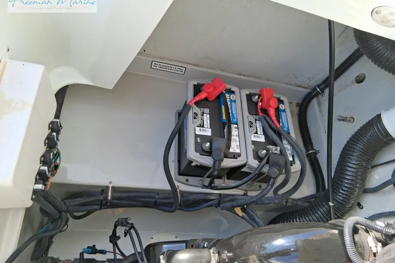 Slide: The Image of Engine compartment of 2007 Baja 245 boat showing dual batteries and wiring setup. - 21