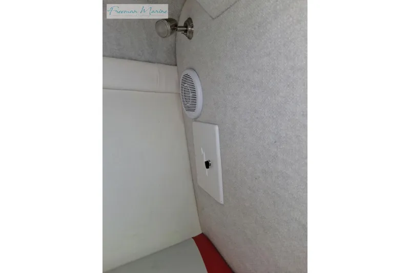 Slide: The Image of Interior of a 2007 Baja 245 boat featuring a speaker and light fixture. - 25