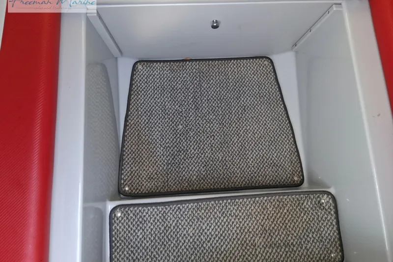 Slide: The Image of 2007 Baja 245 boat interior with red accents and textured flooring. - 26