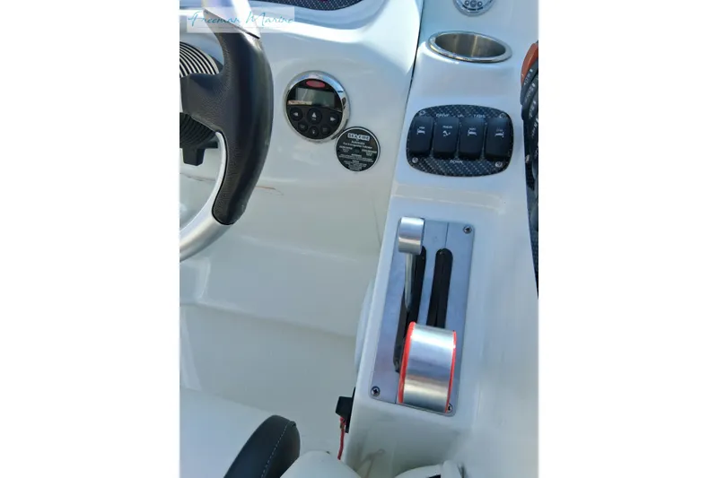 Slide: The Image of Control panel of a 2007 Baja 245 boat with steering wheel and switches. - 29
