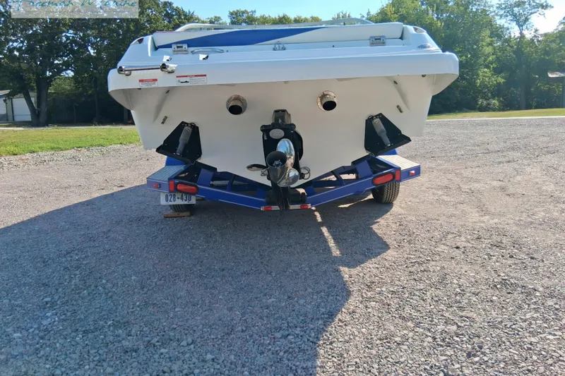 Slide: The Image of Rear view of a 2007 Baja 245 boat on a trailer, parked outdoors. - 3