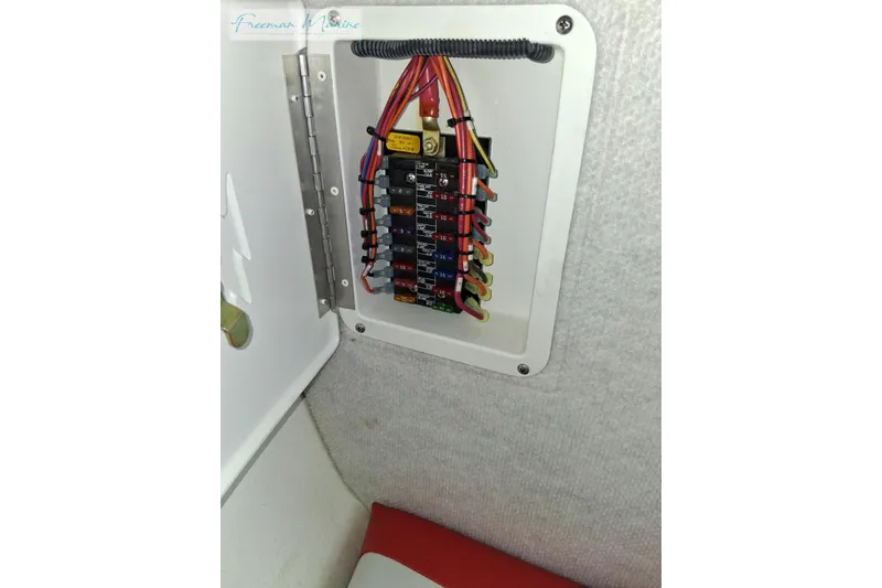 Slide: The Image of Electrical panel with fuses in a 2007 Baja 245 boat interior. - 30