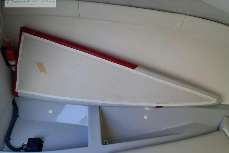 Slide: The Image of 2007 Baja 245 boat interior with fire extinguisher and triangular cushion. - 31