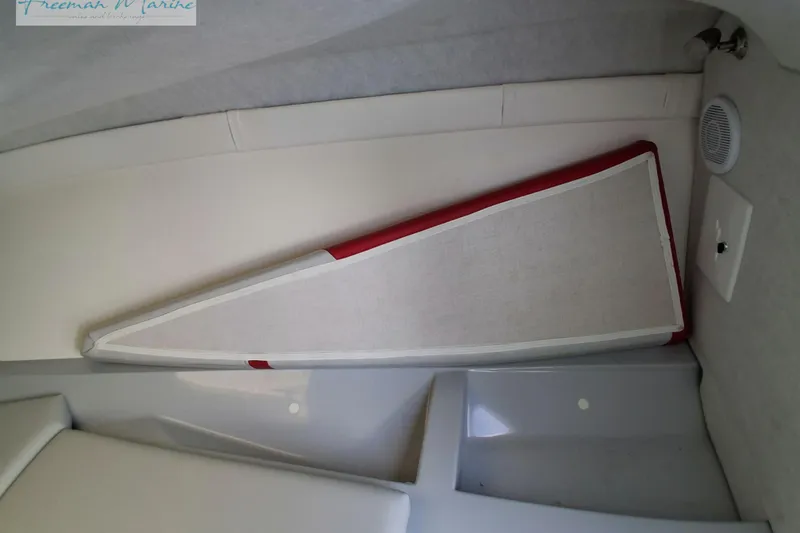 Slide: The Image of Interior of a 2007 Baja 245 boat, featuring a triangular storage compartment. - 32