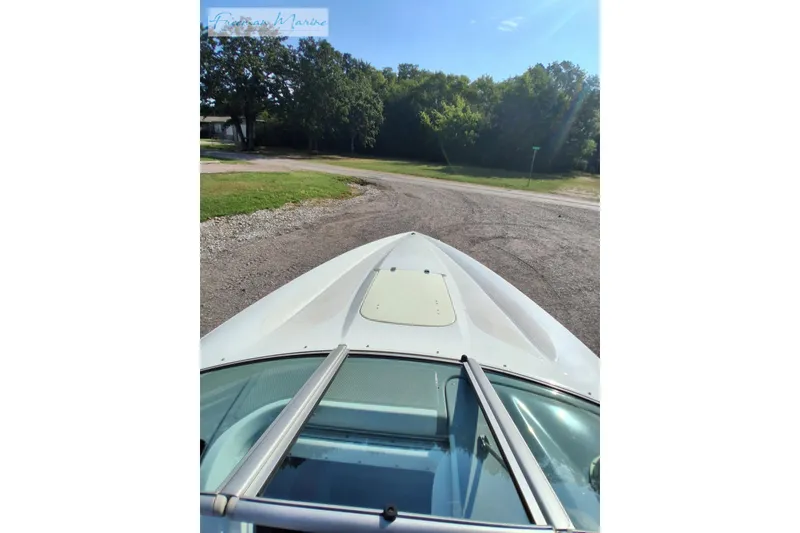 Slide: The Image of 2007 Baja 245 boat bow view with clear sky and trees in background. - 33