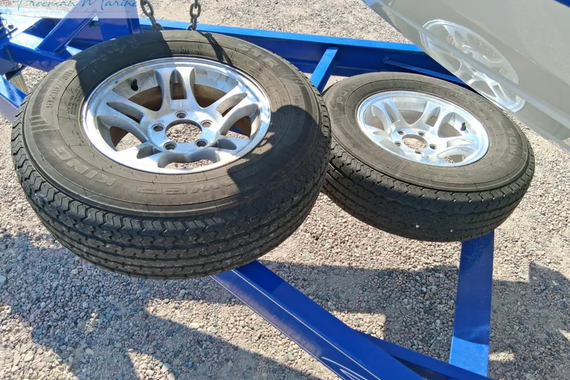 Slide: The Image of Two spare tires on a blue trailer for a 2007 Baja 245 boat. - 37