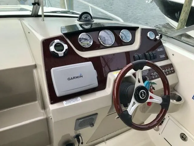Slide: The Image of Dashboard of 2012 Sea Ray 280 Sundancer with Garmin navigation system and wood-trimmed steering wheel. - 10