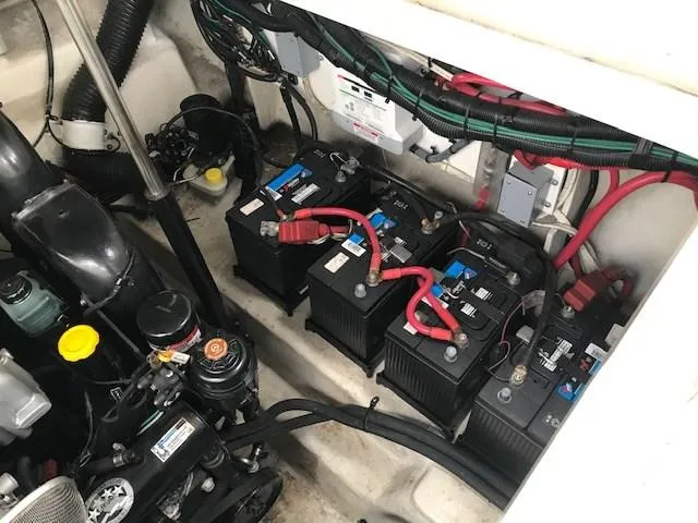 Slide: The Image of Engine compartment of a 2012 Sea Ray 280 Sundancer with multiple batteries and wiring. - 15