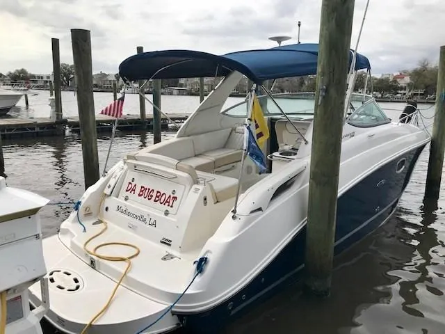 Slide: The Image of 2012 Sea Ray 280 Sundancer docked, featuring blue canopy and custom name "Da Bug Boat." - 2