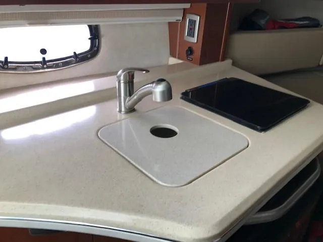 Slide: The Image of 2012 Sea Ray 280 Sundancer kitchen area with sink and countertop. - 20