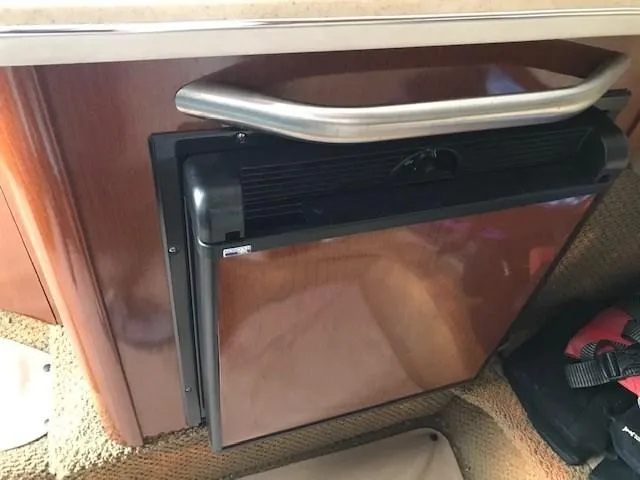 Slide: The Image of 2012 Sea Ray 280 Sundancer cabin interior with compact refrigerator. - 21