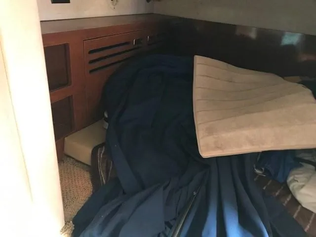 Slide: The Image of Interior cabin of 2012 Sea Ray 280 Sundancer with bedding and storage. - 23