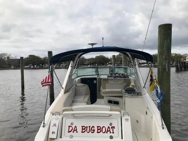 Slide: The Image of 2012 Sea Ray 280 Sundancer boat named "Da Bug Boat" docked by the water. - 4