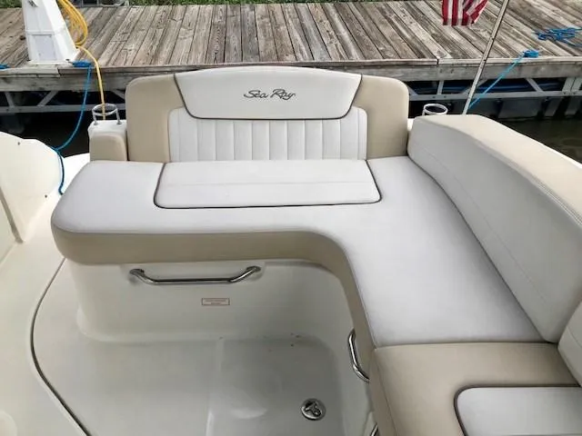 Slide: The Image of 2012 Sea Ray 280 Sundancer boat seating area with beige and white upholstery. - 8