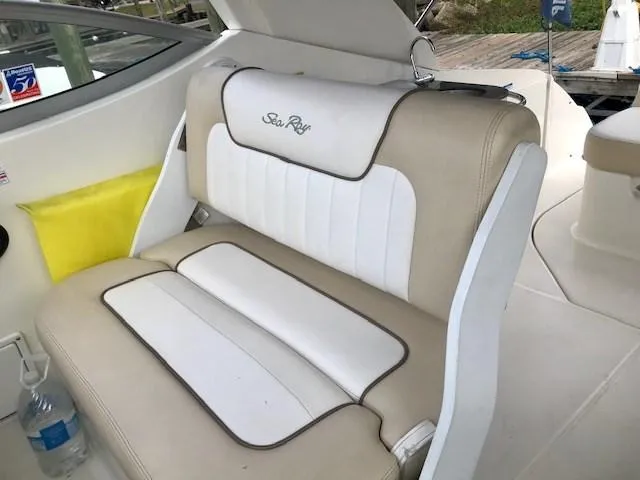 Slide: The Image of 2012 Sea Ray 280 Sundancer interior seating with beige and white upholstery. - 9