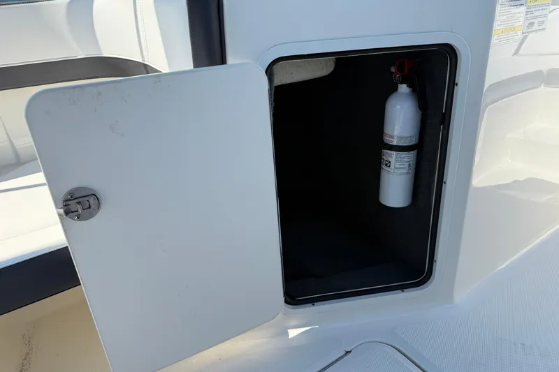 Slide: The Image of 2017 Sea Ray SPX 190 Outboard storage compartment with fire extinguisher. - 2